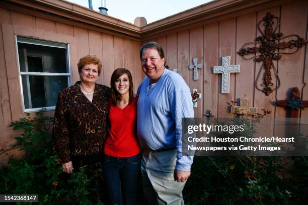 Hazel and Carleton Cole share a laugh with their adopted daughter, Kayla at their home Wednesday, Nov. 18 in Houston. The Cole's adopted Kayla at age...