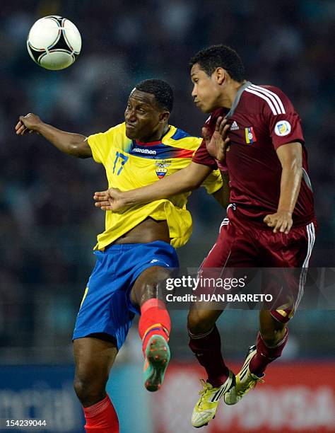 Ecuadorean forward Jaime Ayovi vies for the ball with Venezuelan defender Grenddy Perozo during their FIFA World Cup Brazil 2014 qualifier football...
