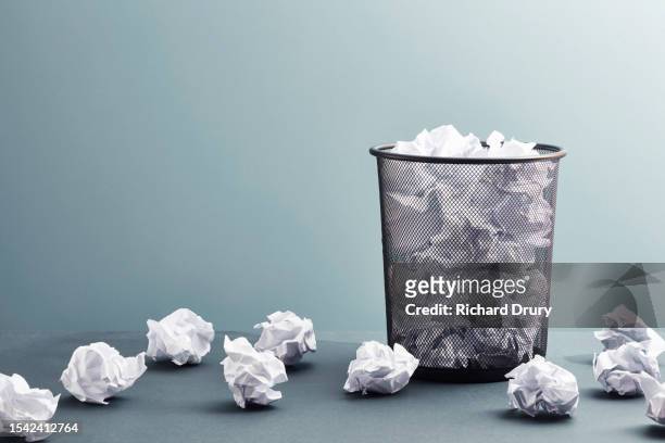a waste paper basket full of waste paper - paper ball stock pictures, royalty-free photos & images