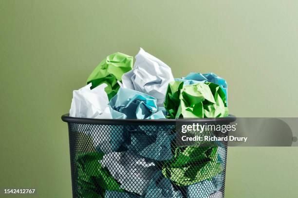 various coloured crumpled papers in a waste paper basket - wastepaper basket stock-fotos und bilder