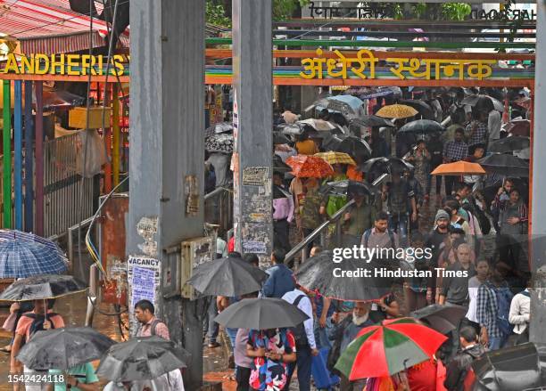 People seen walking holding umbrellas as the maximum city received heavy rainfall at Andheri, on July 19, 2023 in Mumbai, India.