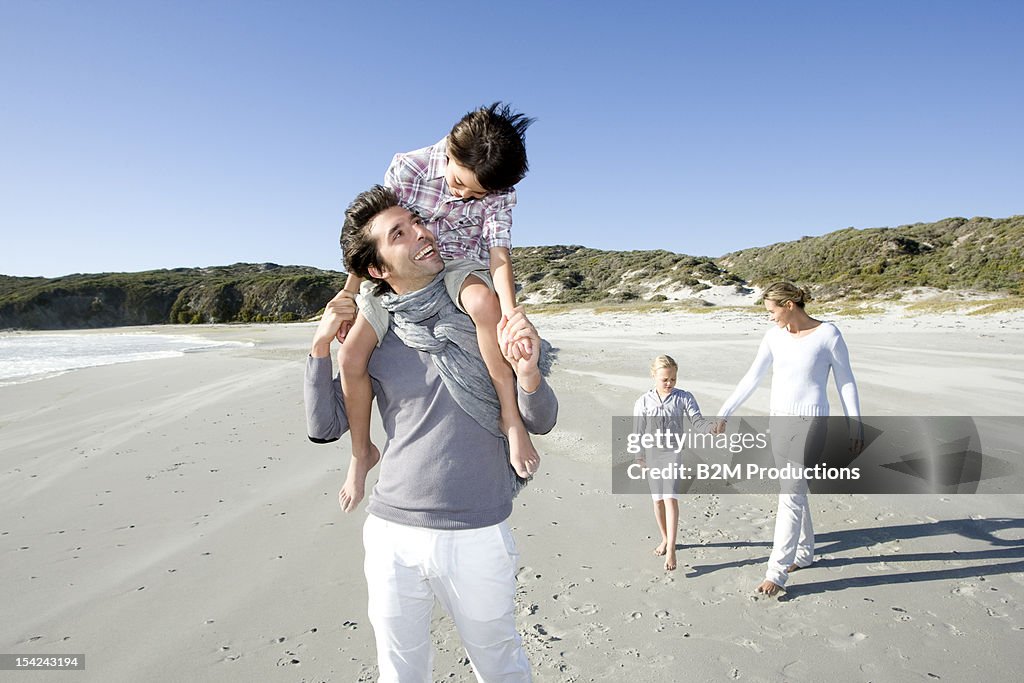 A happy family walking on the beach