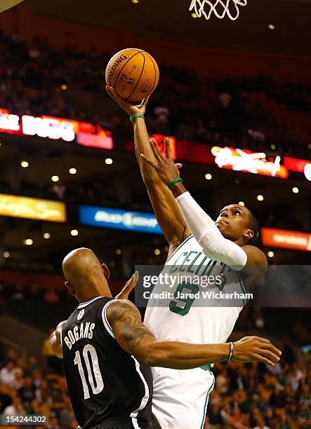 Rajon Rondo of the Boston Celtics drives to the basket for a layup in front of Keith Bogans the Brookyln Nets during the preseason game on October...