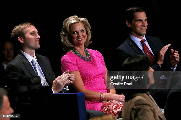 Ann Romney sits with sons Ben Romney and Matt Romney before the presidential town hall style debate at Hofstra University October 16, 2012 in...