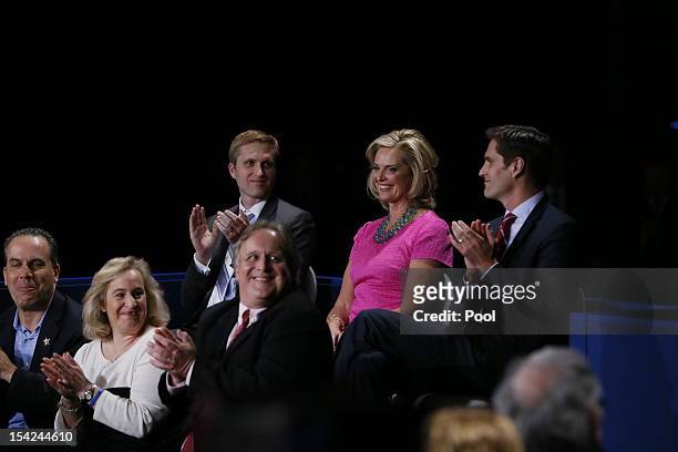Ann Romney sits with sons Ben Romney and Matt Romney before Republican presidential candidate Mitt Romney and U.S. President Barack Obama answer...