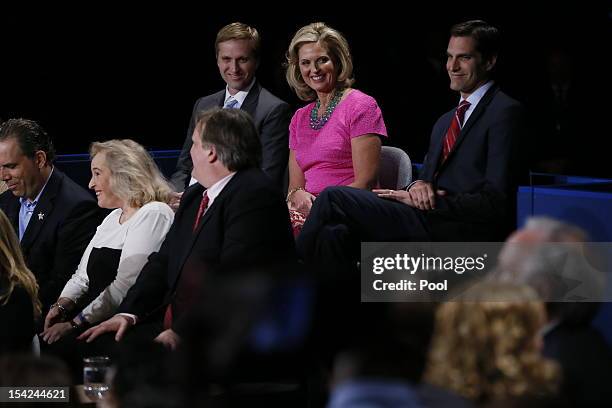 Ann Romney sits with sons Ben Romney and Matt Romney before Republican presidential candidate Mitt Romney and U.S. President Barack Obama answer...