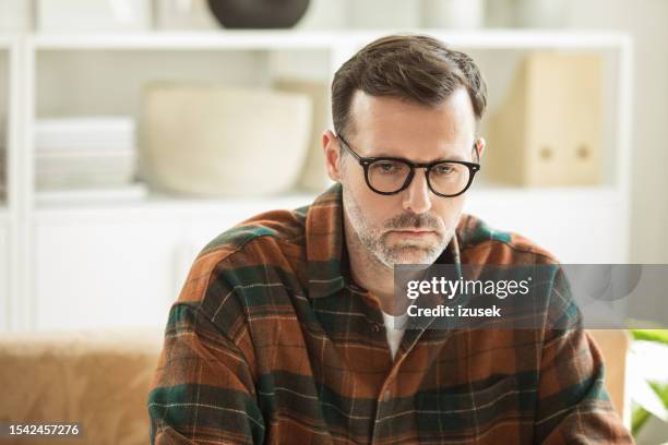 sad mature man sitting with mug at home - checked shirt stock pictures, royalty-free photos & images