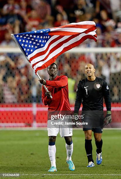 Eddie Johnson of the USA waves an American flag as goalkeeper Tim Howard looks on after the USA defeated Guatemala 3-1 to win the World Cup...