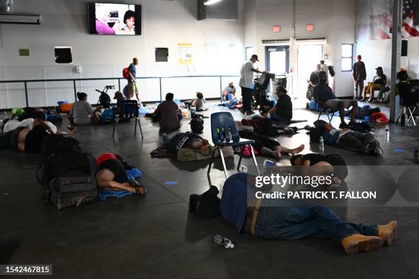 Phoenix residents watch a movie while seeking protection from the sun and heat inside a dining hall from The Society of St. Vincent De Paul on the...