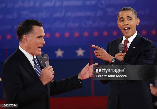 Republican presidential candidate Mitt Romney and U.S. President Barack Obama talk over each other as they answer questions during a town hall style...