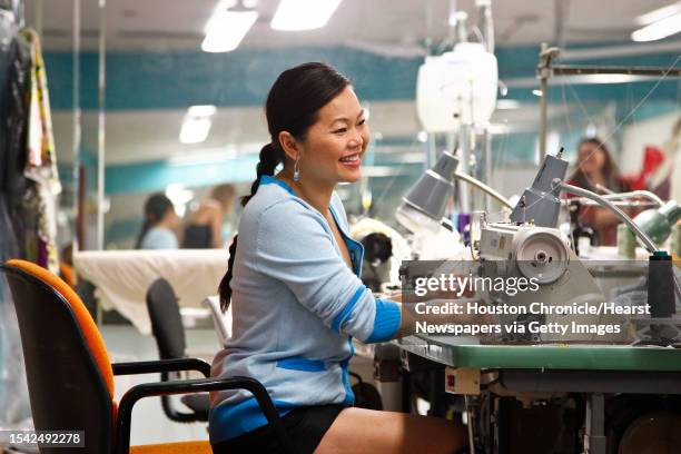 Fashion designer Chloe Dao sews a muslim fit sample which she will use to create a finished piece for the upcoming Audi Houston Fashion Week while...