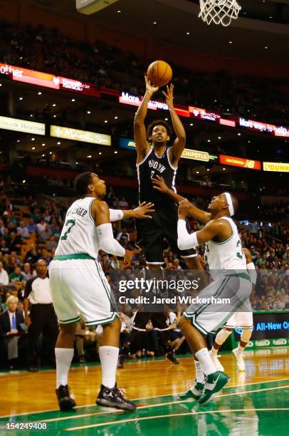 Josh Childress of the Brookyln Nets takes a shot over Jared Sullinger and Paul Pierce of the Boston Celtics during the preseason game on October 16,...