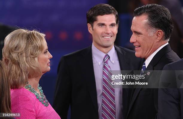 Republican presidential candidate Mitt Romney speaks with wife Ann Romney, while son Matt Romney looks on after a town hall style debate at Hofstra...