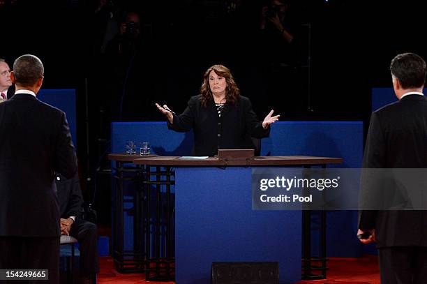 President Barack Obama and Republican presidential candidate Mitt Romney listen to moderator Candy Crowley during a town hall style debate at Hofstra...