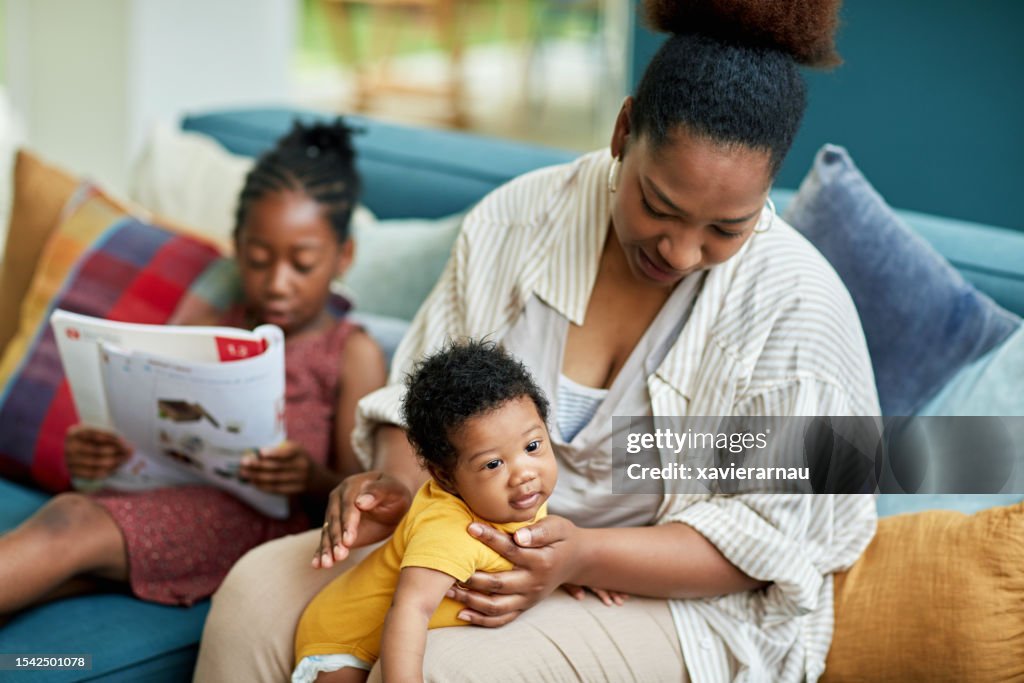 Black family with two children relaxing at home