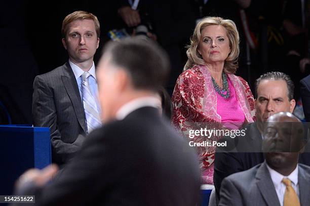 Republican presidential candidate Mitt Romney answers a question as son Ben Romney and wife Ann Romney look on from the audience during a town hall...