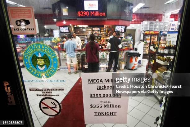 People buy lottery tickets at the Phillips 66 at Weslayan and Highway 59 before the $355-million MEGA Millions Jackpot drawing Tuesday, Jan. 4 in...