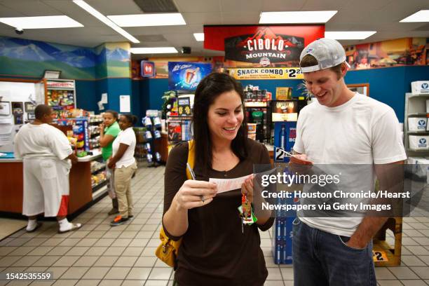 Anne Porembski and Jeff Nelson buy lottery tickets at the Valero Gas Station at Montrose and Westheimer before the $355-million MEGA Millions Jackpot...