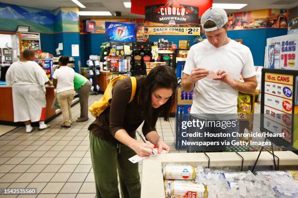 Anne Porembski and Jeff Nelson buy lottery tickets at the Valero Gas Station at Montrose and Westheimer before the $355-million MEGA Millions Jackpot...