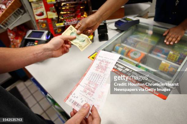 People buy lottery tickets at the Valero Gas Station at Montrose and Westheimer before the $355-million MEGA Millions Jackpot drawing Tuesday, Jan. 4...