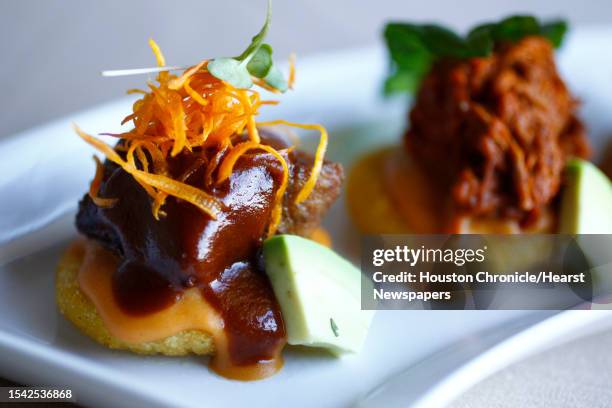 Arepitas, traditional corn bread dough stuffed with Oaxaca cheese, bean sauce, served with three meats, at Latin Bites, a new Peruvian Cafe,...
