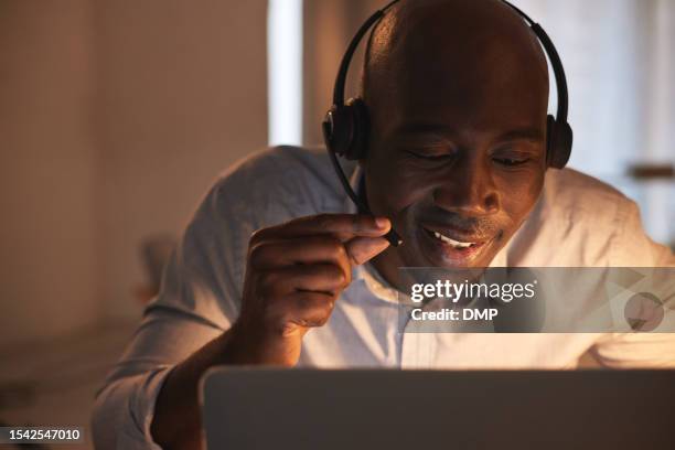 black man, night and callcenter, contact us and phone call communication and telemarketing with advice. customer service, help desk and telecom with crm, online with male consultant working overtime - callcenter stock pictures, royalty-free photos & images