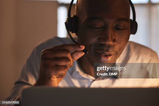 black man, night and callcenter, face with contact us and phone call, communication and telemarketing with advice. customer service, help desk and telecom with crm, male consultant working overtime - callcenter stock pictures, royalty-free photos & images