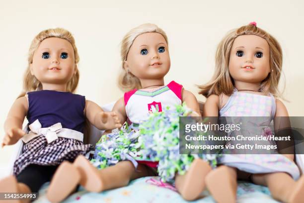 Lauren Geczik and her sister, Kristin Geczik display their collection of American Girl dolls at their family home, Saturday, Sept. 8 in Houston.