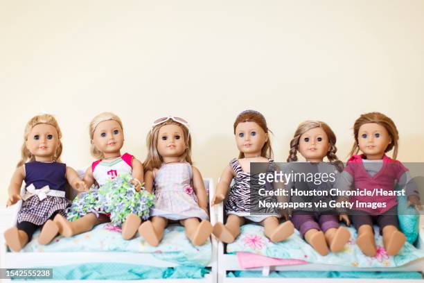 Lauren Geczik and her sister, Kristin Geczik display their collection of American Girl dolls at their family home, Saturday, Sept. 8 in Houston.