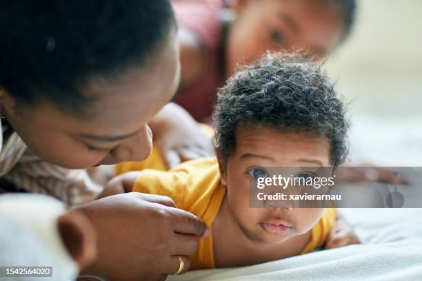 black baby boy, mother, and sister - baby close up bed stock pictures, royalty-free photos & images