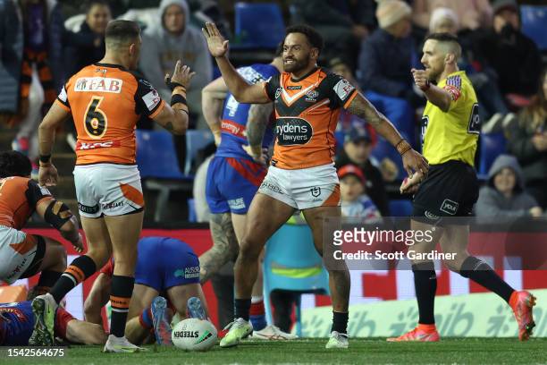 Apisai Koroisau of the Tigers celebrates his try during the round 20 NRL match between Newcastle Knights and Wests Tigers at McDonald Jones Stadium...