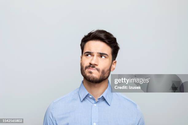 headshot of worried businessman - confuso imagens e fotografias de stock