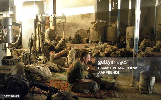 Picture released by the US Marines shows marines with 3rd Platoon, Company A, 1st Battalion, 5th Marine Regiment taking cover and a break inside a...