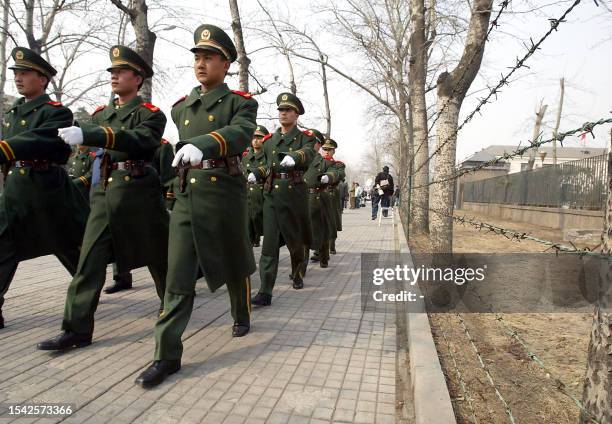 Chinese paramilitary guards march near the Japanese embassy in Beijing 26 March 2004, as a group Chinese protesters are demonstrating. Chinese...