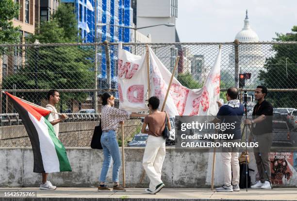 Activists with The Palestinian Youth Movement and the Party for Socialism and Liberation display a banner over North Capitol Street near the US...