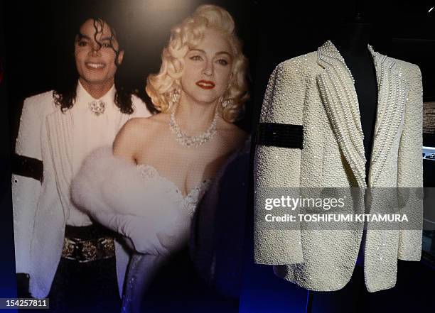 Late US pop star Michael Jackson's 'Academy Awards' jacket is displayed next to a picture of Jackson wearing the jacket as he stands next to pop star...