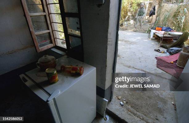 Soldier from the 4-42 Field Artillery Division keeps guard at the farm house from where Iraqi ex-dictator Saddam Hussein was captured by the US...