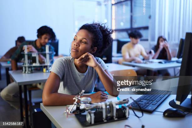 thoughtful black scientist in a computer classroom. - school science project stock pictures, royalty-free photos & images