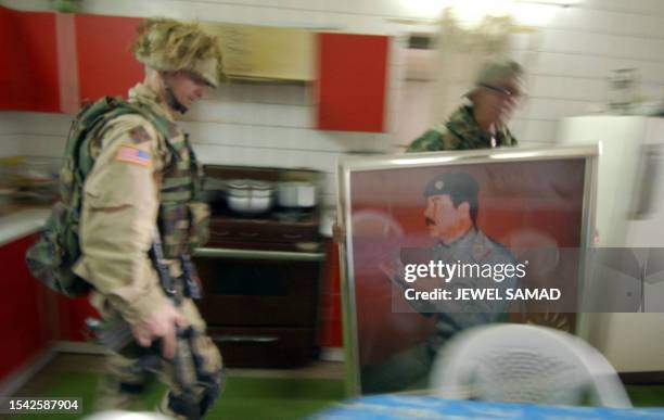 Commander of the 1st Battalion, 22nd Infantry Regiment of US army's 4th Infantry Division, Colonel Steve Russell watches one of his men carry out a...