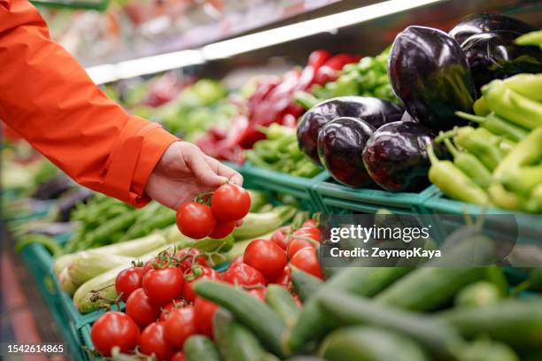 man shopping vegetables in groceries store - supermarket fruit stockfoto's en -beelden