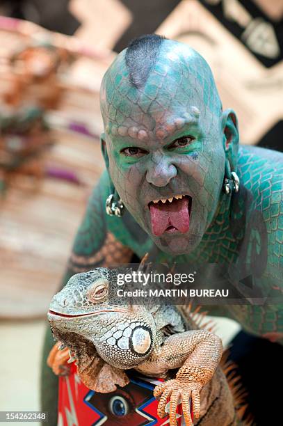 Erik Sprague, also known as "The Lizardman", poses with an iguana during the launching of the book "Le Big Livre de l'Incroyable" , on October 17,...