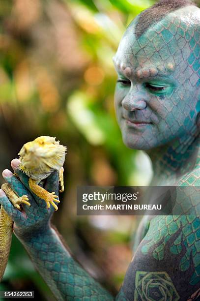 Erik Sprague, also known as "The Lizardman", poses during the launching of the book "Le Big Livre de l'Incroyable" , on October 17, 2012 in Paris....