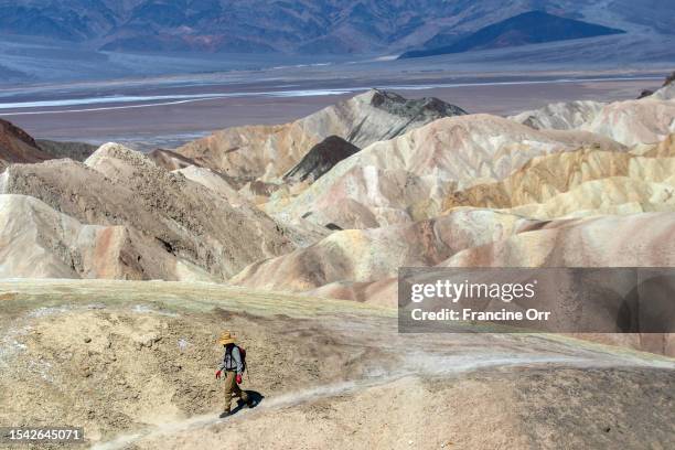 Death Valley, CA Steve Curry of Sunland, is walking to Zabriskie Point in Death Valley National Park on Tuesday, July 18 in Death Valley, CA. It was...