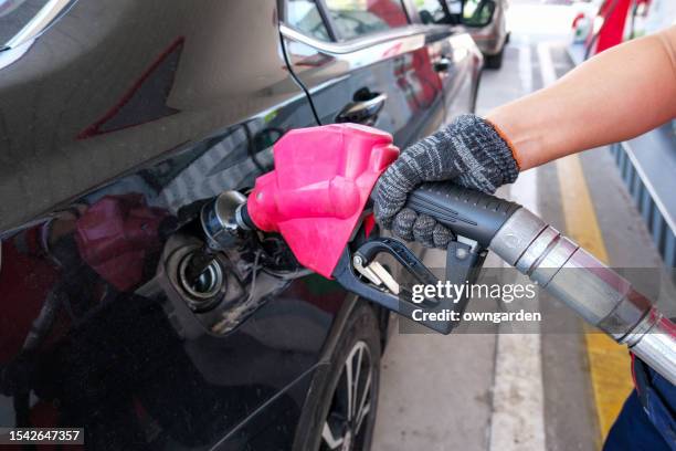 filling up the tank with petrol - diesel fuel stock pictures, royalty-free photos & images
