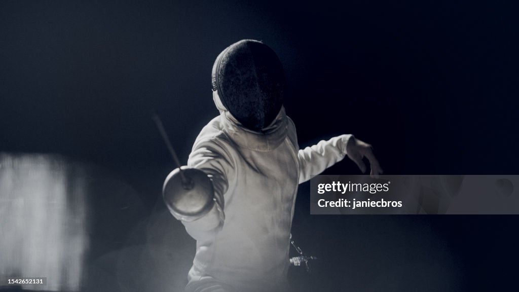 First person POV two professional fencers foil swords facing each other in combat. Blur effect