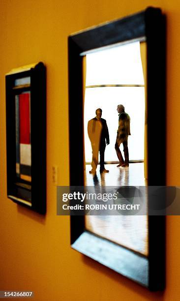 Guard is reflected in the glass of a painting at the Kunsthal museum in Rotterdam on October 17, 2012 a day after seven masterpieces worth up to 200...