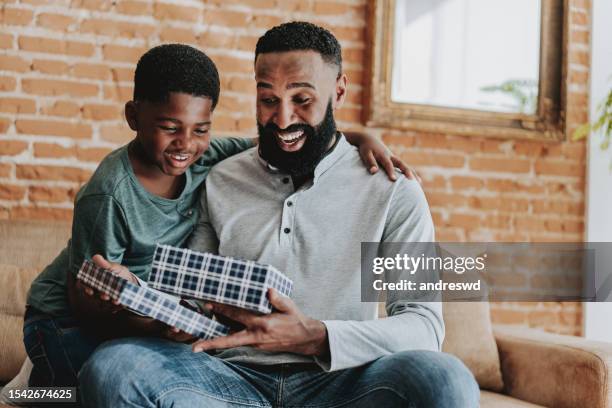 child handing gift box on father's day - fathers day stock pictures, royalty-free photos & images