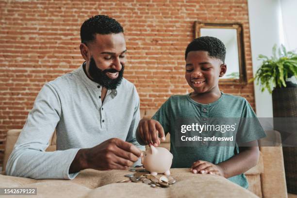 father and son coin bank - child saving stock pictures, royalty-free photos & images