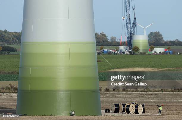 Worker pulls on a rope to secure equipment at a wind turbine under construction at the Werder/Kassin RH2-WKA windpark on October 17, 2012 near...