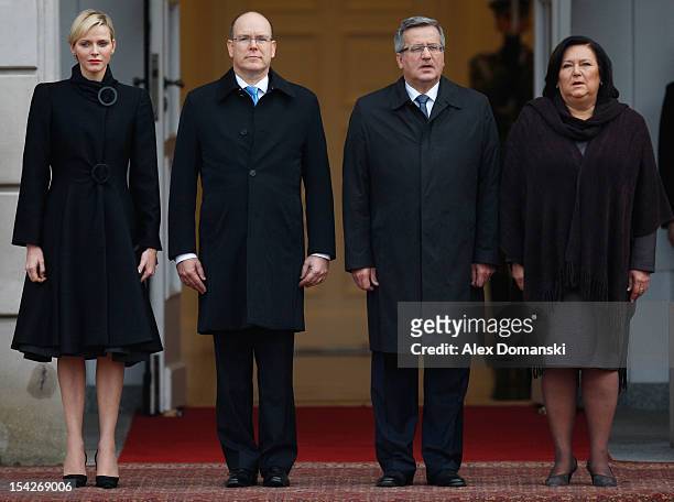 Princess Charlene of Monaco and Prince Albert II of Monaco stand with Polish President Bronislaw Komorowski and his wife Anna Komorowska on state...
